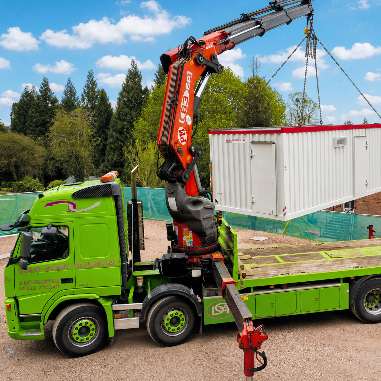 Doug Gobey crane vehicle lifting a site cabin, supervised by site staff