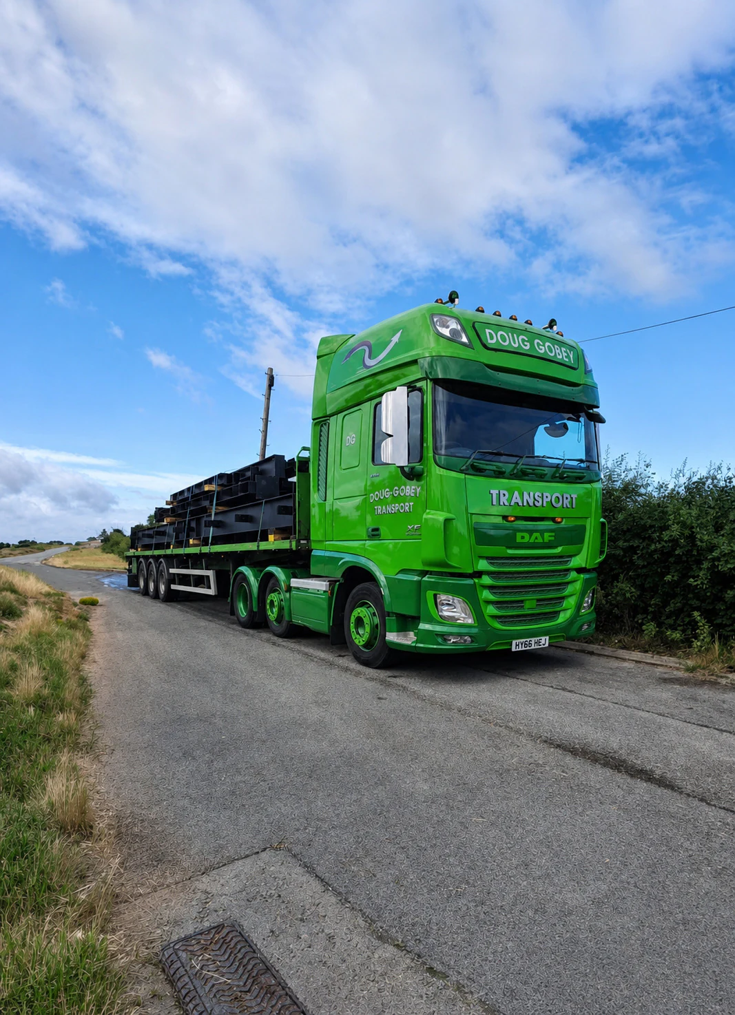 Doug Gobey flatbed lorry carrying building materials on a site road