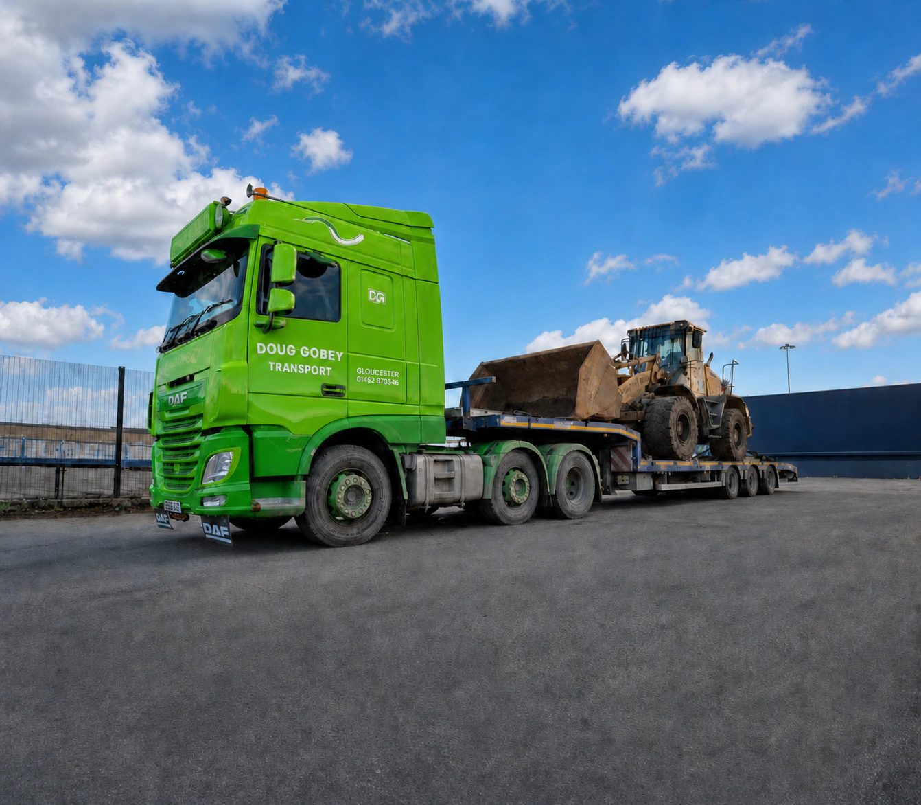 Doug Gobey low-loader carrying a wheel loader