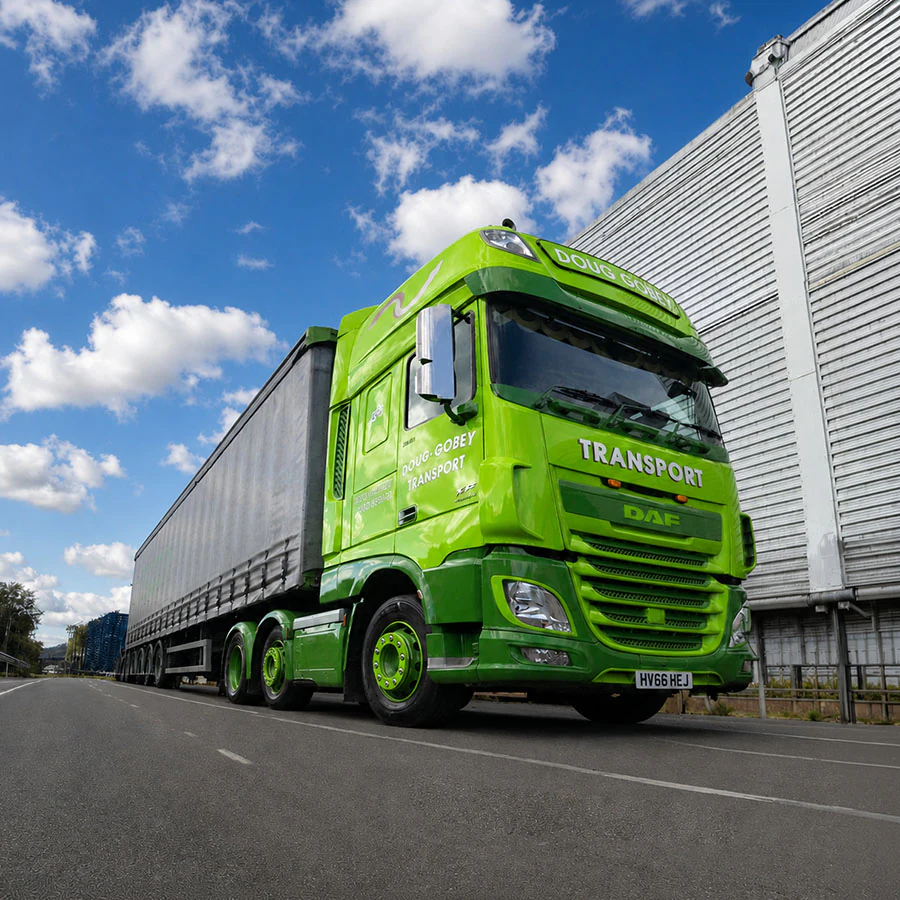 Doug Gobey curtain-side lorry outside a large warehouse unit