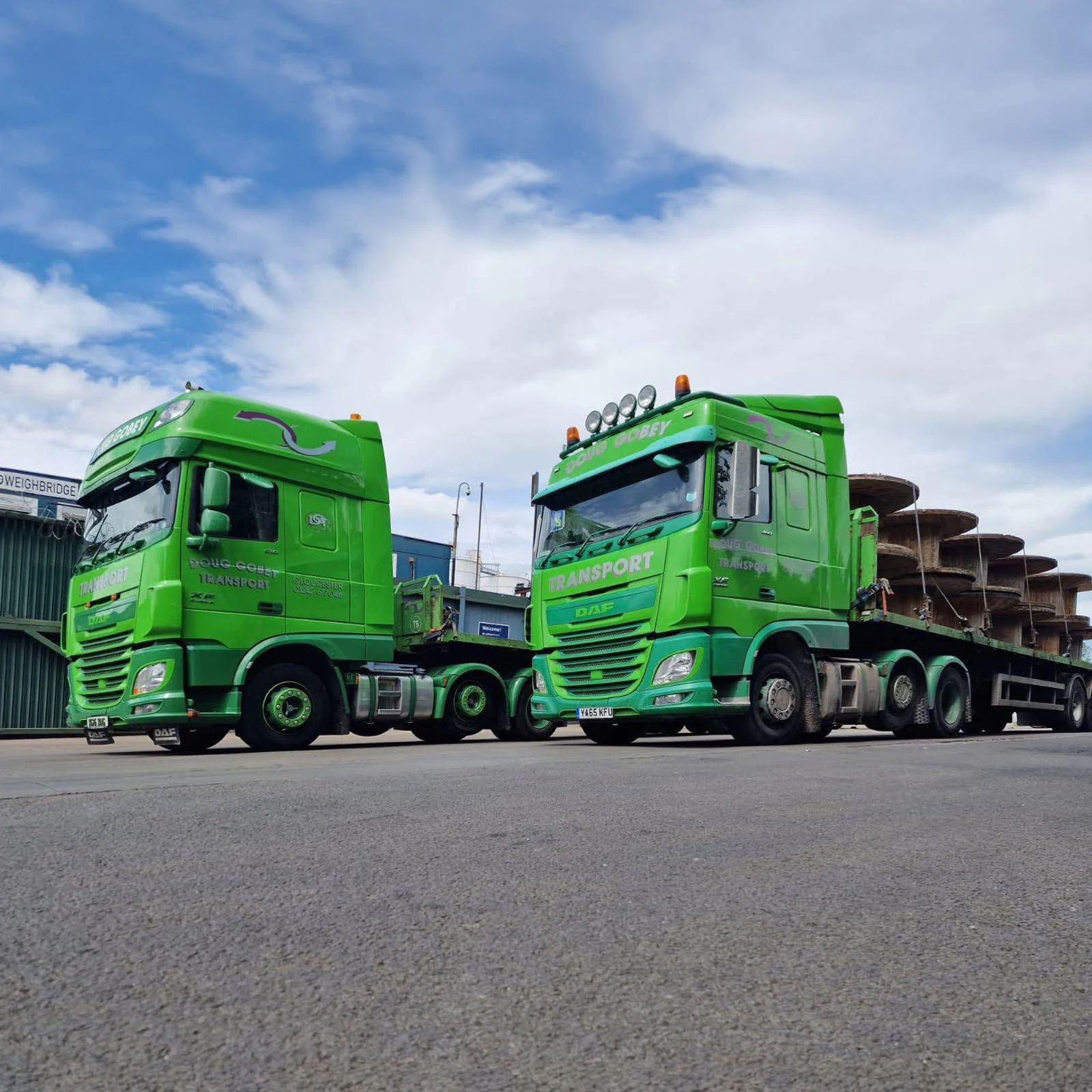 Two Doug Gobey Transport lorries loaded with large cable reels