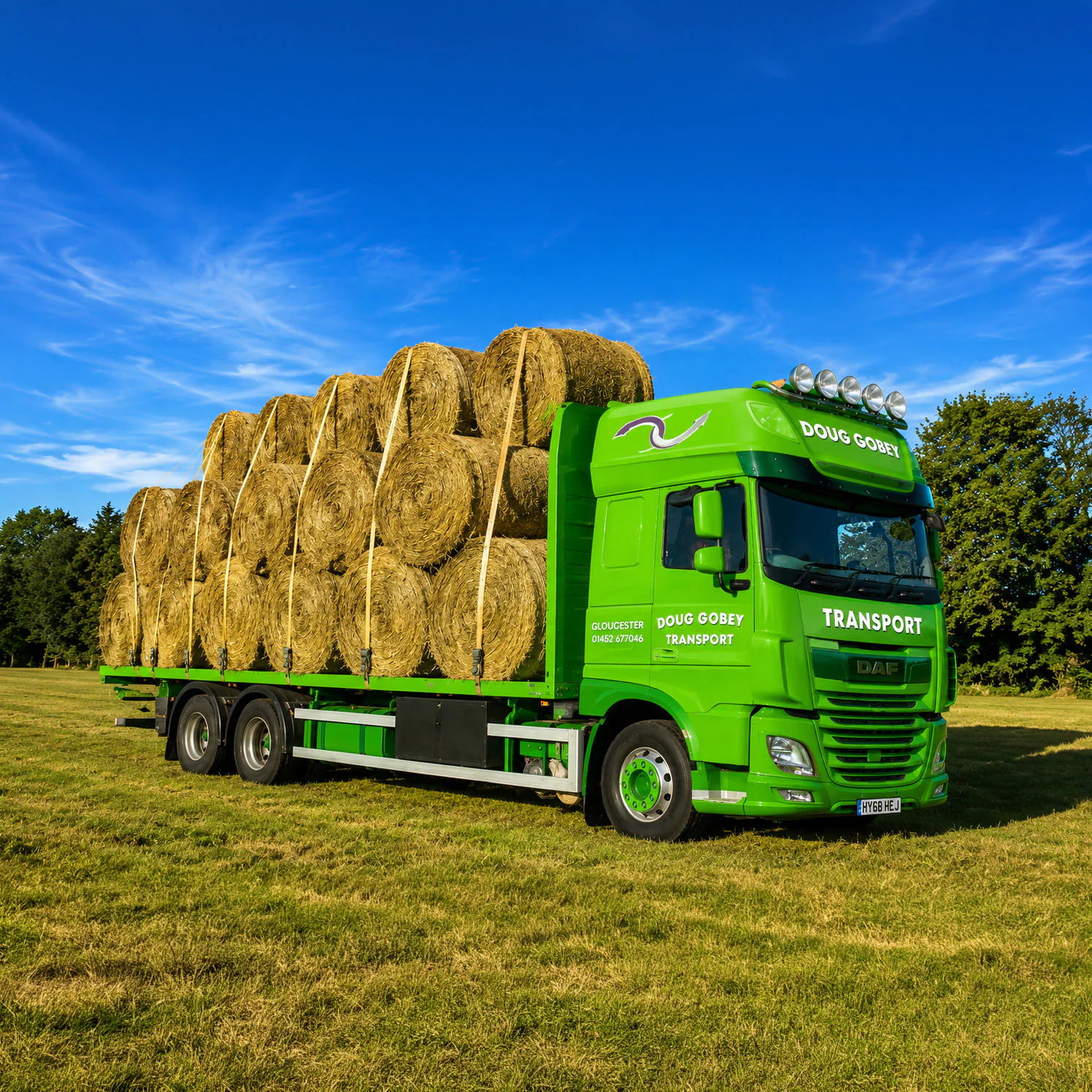 A Doug Gobey Transport lorry loaded with hay bales, reflecting the business's agricultural roots