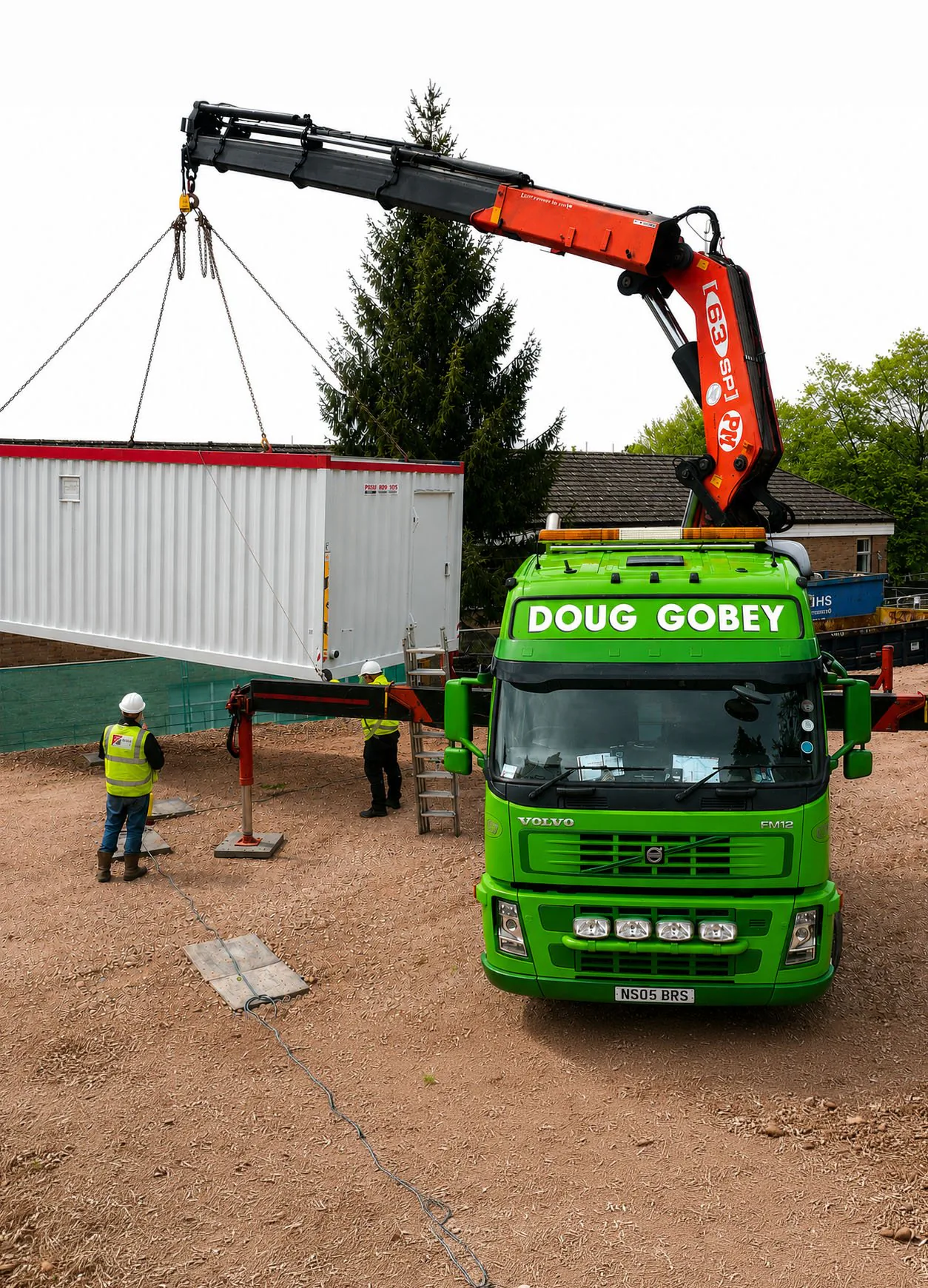 Doug Gobey crane vehicle carefully lifting a container under supervision of site staff