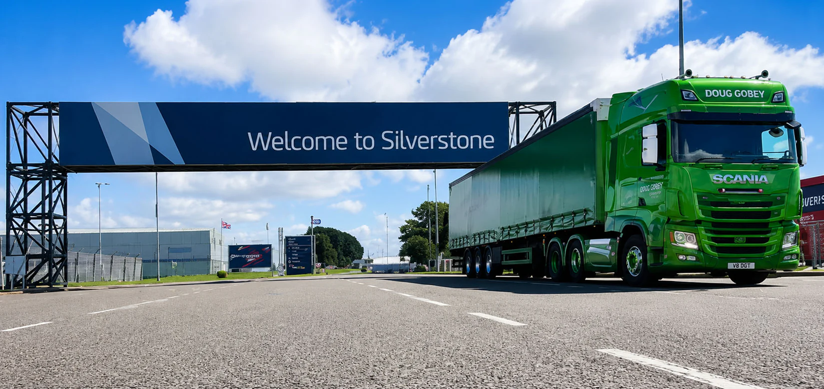 Doug Gobey curtain-side lorry passing under the Welcome to Silverstone gantry